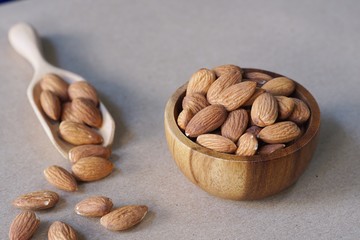 Almond nut in wood bowl on wooden table background