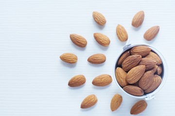Almond nut in wood bowl on white table background