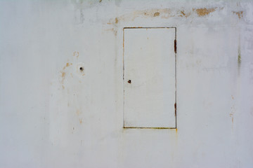 White wall with metal door without steps