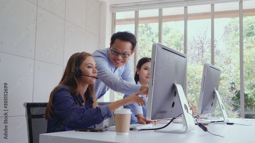 Aufkleber customer support agent or call center with headset works on desktop computer while supporting the cu