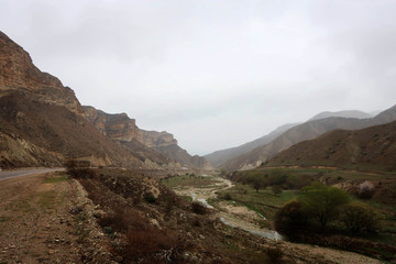 Fototapeta premium Scenic misty mountain road in Dagestan view, Russia