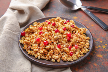 Plate with tasty granola and berries on table