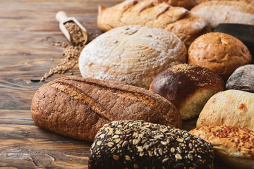 Different fresh bread on wooden table