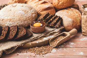 Different fresh bread on wooden table