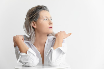 Beautiful woman with creative makeup on white background