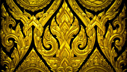 Closeup Thai pattern carving Kanok picture at door in temple