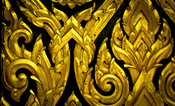 Closeup Thai pattern carving Kanok picture at door in temple