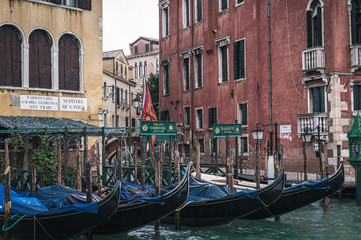 Fototapeta na wymiar Venice, Veneto, Italy - 15.11.2019, View of gondolas and typical Venetian houses and architecture. Beautiful and romantic Italian city on water. 