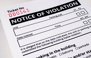Plain notice of violation ticket for building bylaws. Close up.  Strata or rental property...