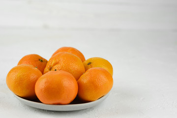sweet and ripe whole and peeled mandarins (tangerines) on white background isolated