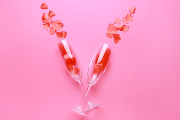 Glasses with hearts on color background. Valentine's Day celebration