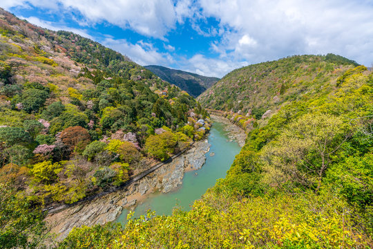 Beautiful colorful forest mountains and river with blue sky view at katsura river lake to Arashiyama mountain Kyoto, Japan. idea for rest relax enjoy lifestyle