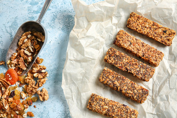 Tasty granola and bars on table