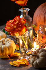 Fototapeta na wymiar Autumn wedding decoration with pumpkins, orange roses and candles.