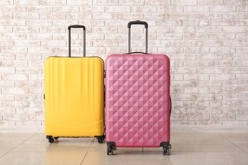 Suitcases near brick wall. Travel concept