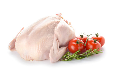 Raw chicken with herbs and tomato on white background