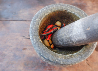 Stone mortar with chilli pepper For making curry in Thai food Important tools for making chili paste