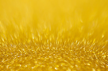 Rich golden sparkle glow bokeh texture as background.