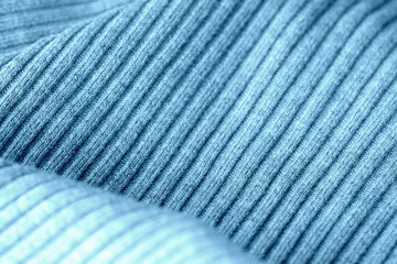 Knitwear texture close-up. Textile background blue color toned