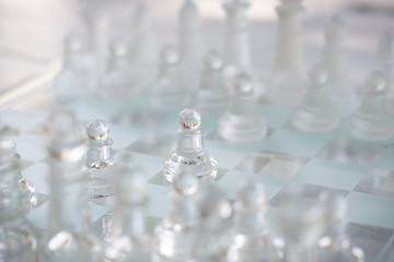 Chess board game made of glass, business competitive concept