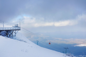 Funicular for tourists, skiers and snowboarders. lift to transport people in the mountains. the cable car on the background of blue mountains.
