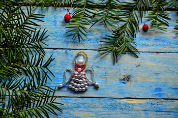 Christmas angel in composition on a blue background.