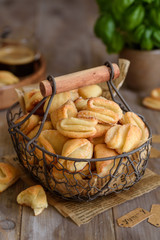 Curd sugar cookies crow's feet in a metal basket on a wooden table. Cottage cheese biscuits . Selective focus