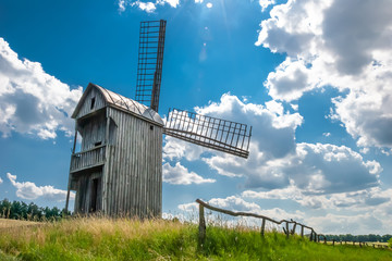 Windmill on a wheat field in the sun