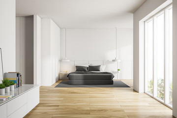 White master bedroom with bookshelf