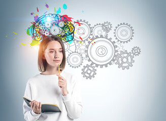 Young woman with notebook brainstorming