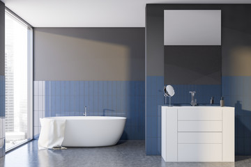 Gray and blue tile bathroom interior, tub and sink