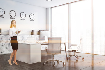 Woman in white CEO office with clocks