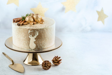 Christmas cake on golden cake stand. Copy space.