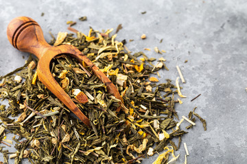 Dry green tea leaves and dry orange zest. Green tea leaves. 