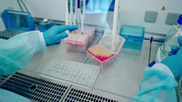 Medical equipment blood test in laboratory. Female technician analyzing blood sample in medical laboratory
