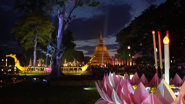 Stupa at Sukhothai Historical Park with illuminated dragon boat, Loy Kratong 2019.