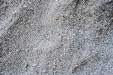 A large pile of gray sand. Background. Texture.