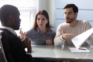Angry clients couple argue with agent for paperwork contract mistake