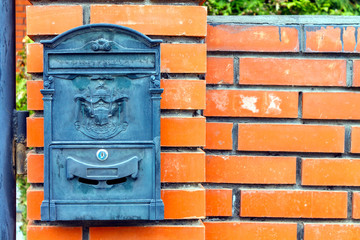 A beautiful mailbox hangs waiting for newspapers, parcels and letters.