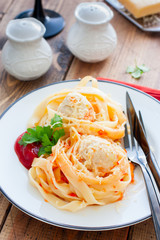Tagliatelle pasta with meat balls and sauce, selective focus
