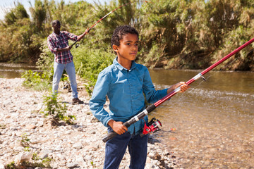 Boy pulling fish