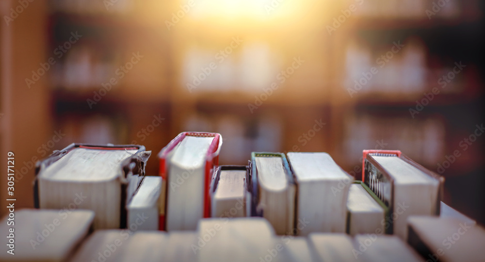 Poster stack of books in the library and blur bookshelf background