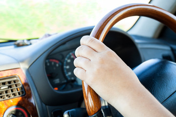 Hands on the steering wheel. Right-hand drive car.