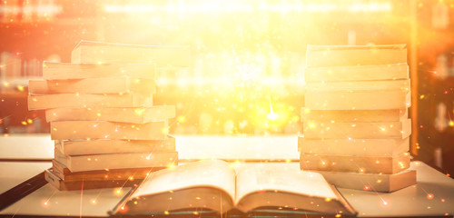 The blurred book that is bewitched with magic, the magic light in the dark, with the bright light shining down as the power to search for knowledge. For research and use as a blurred background