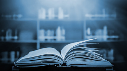 Stack of books in the library and blur bookshelf background