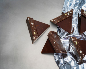 Flat lay composition with cocoa powder and chocolate on grey backgroundFlat lay composition with tasty chocolate on grey background. Space for text