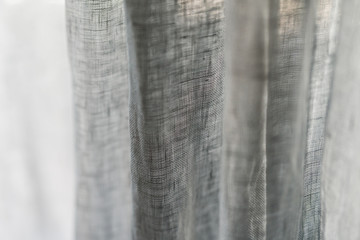 Closeup of linen curtains on a window