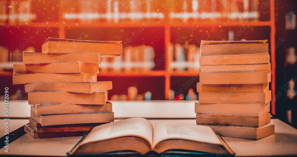 Poster stack of books in the library and blur bookshelf background