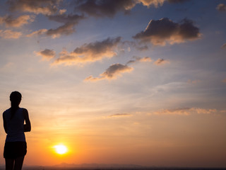 Obraz premium Free young woman at golden sunset. Freedom and success concept,relaxing and enjoying nature with copy space.