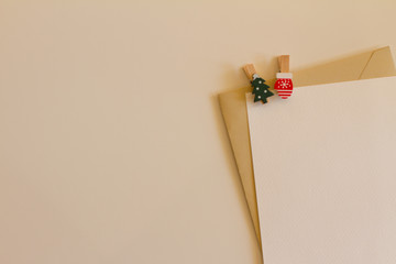 letter with envelope on pink background. Christmas background. Christmas tree and mittens. the view from the top. space for text. festive mood. letter to Santa Claus.